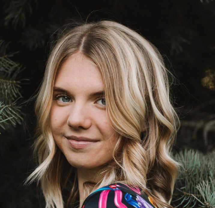 Maria wearing a black blouse with pink stripes